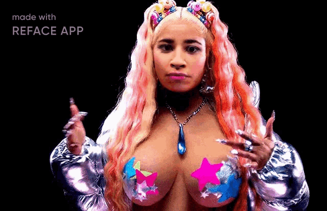 a woman with pink hair and stars on her breasts is wearing a silver jacket and a necklace .