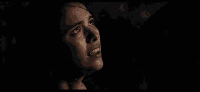 a close up of a woman 's face with water coming out of her eyes