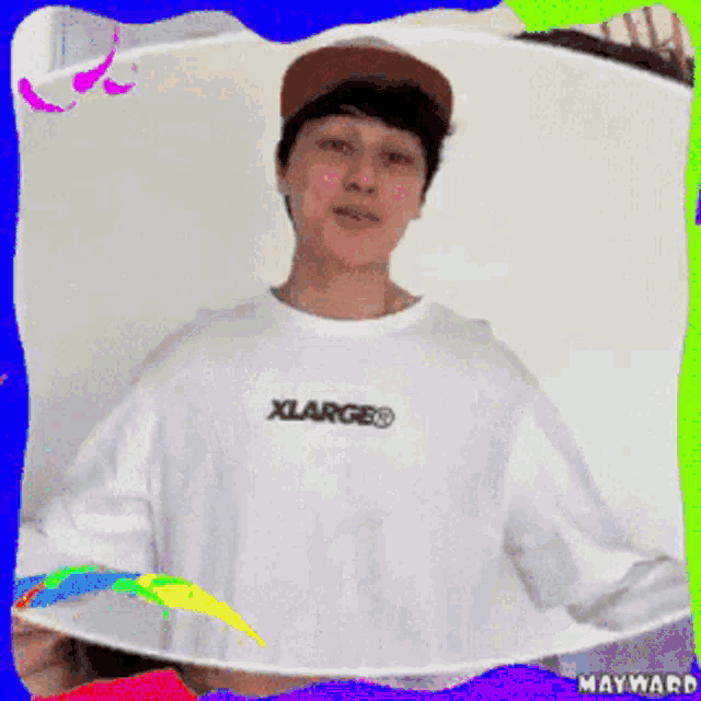 a man wearing a white xlarge shirt and a hat