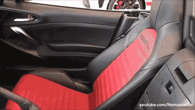 a red seat in a car with the word abarth written on it