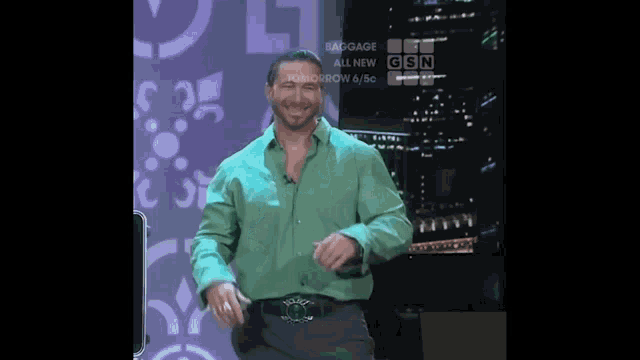 a man in a green shirt is dancing in front of a sign that says tomorrow at 9