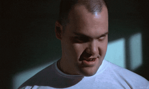 a close up of a man 's face with a white shirt that says zucch on the bottom