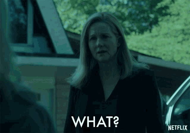 a woman in a black jacket is asking what