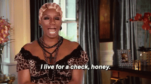a woman in a leopard print dress is screaming and saying i live for a check , honey .