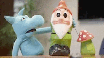 a blue stuffed animal talking to a gnome