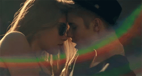 a close up of a man and woman kissing