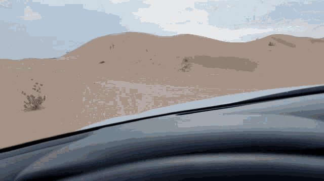 a view of a desert from a car dashboard