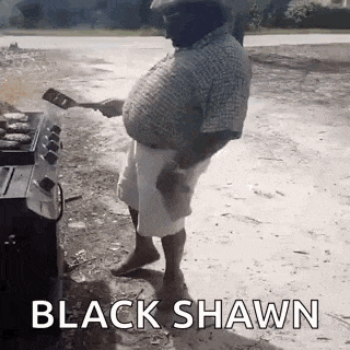 a man is cooking hamburgers on a grill in a yard .