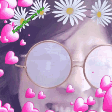 a woman wearing round glasses is surrounded by pink hearts and daisies with the words butterflies are free on the bottom