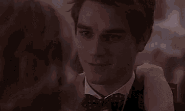 a man in a suit and bow tie is hugging a woman .