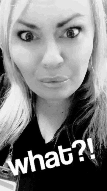 a woman is making a funny face with the words what written on her face