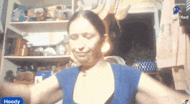 a woman in a blue shirt with the word hoody on the corner