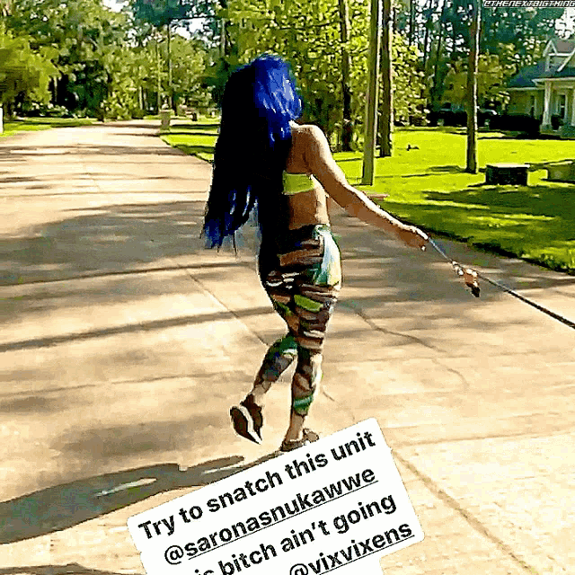 a woman with blue hair is walking on a leash