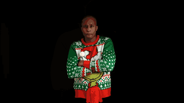 a man wearing an ugly christmas sweater with grinch on it