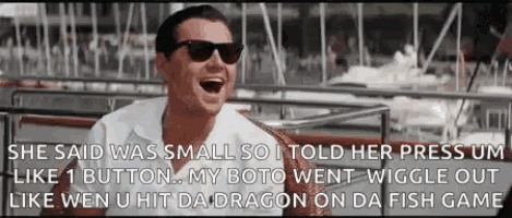 a man wearing sunglasses and a white shirt is laughing .