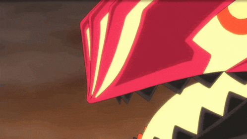 a close up of a red and yellow object with a yellow circle in the middle