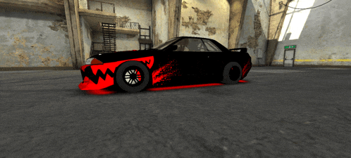 a black car with a red shark design on the front is parked in a garage