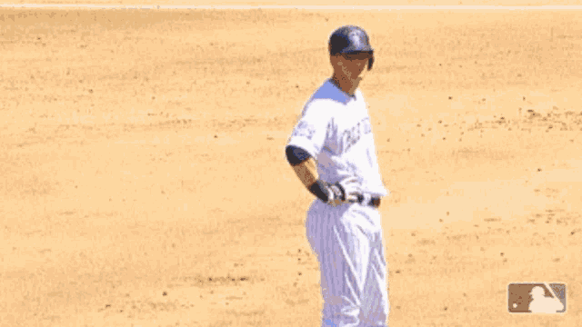 a baseball player wearing a white uniform with the word rockies on the front