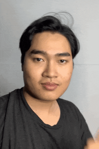 a close up of a man 's face with a black shirt on