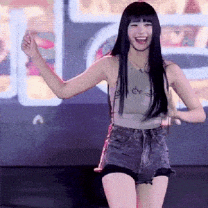 a woman in a tank top and shorts is dancing