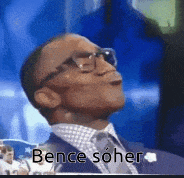 a man in a suit and tie is making a funny face with the words bence soher written below him .