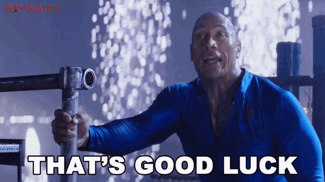 a man in a blue shirt with the words that 's good luck on the bottom