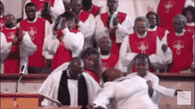 a group of people are standing in front of a podium in a church choir .