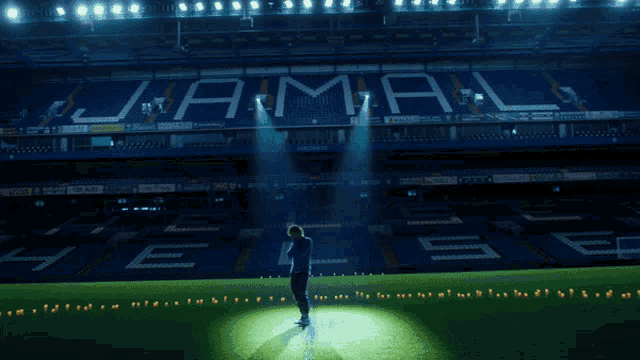 a woman stands in front of a stadium that says jamal on it