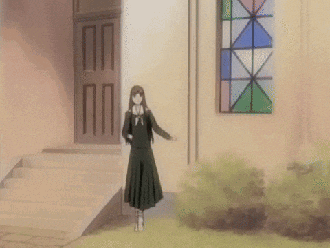 a girl is standing in front of a building with a stained glass window in the background