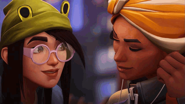 a woman wearing a green hat with frog eyes looks at another woman wearing glasses