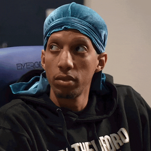 a man wearing a blue headband and a black shirt that says the word