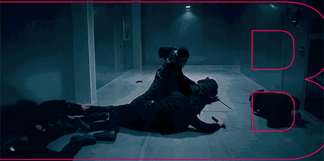 a man laying on the floor with a sword in his hand