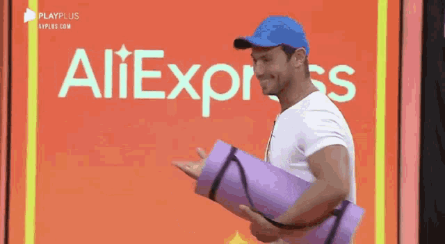 a man is holding a yoga mat in front of an aliexpress logo