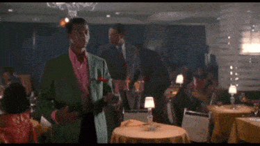 a man in a green suit stands next to another man with the words my love written on the screen