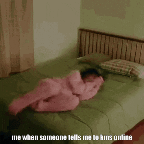 a woman in pink pajamas is sitting on a bed with the words me when someone tells me to kms online below her