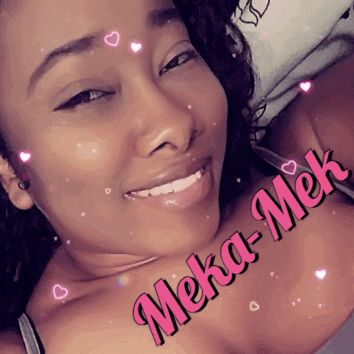 a woman is smiling and has the name meka-mek on her chest