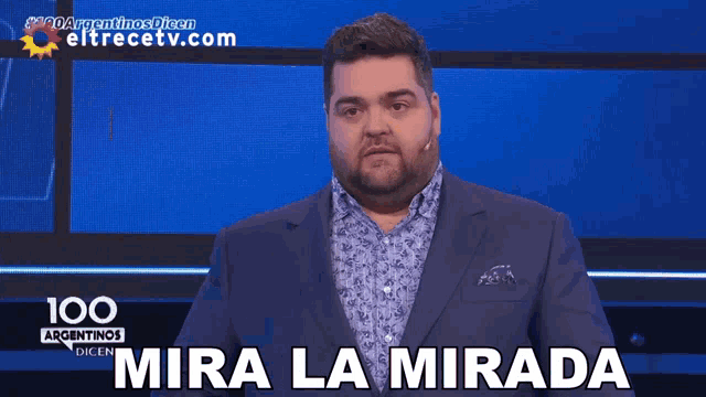 a man in a suit says mira la mirada on a screen