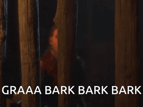 a man behind bars with the words graaaa bark bark bark