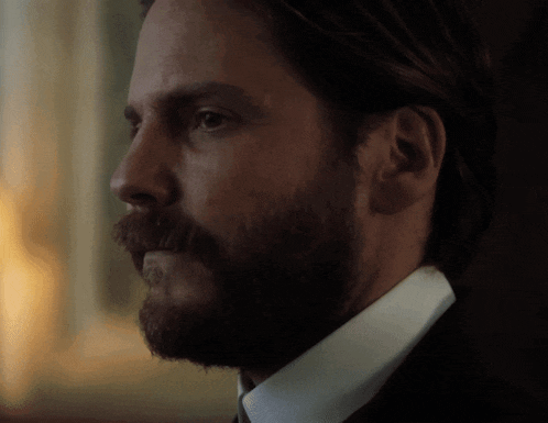 a man with a beard wearing a white shirt and tie