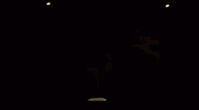 a teddy bear is dancing in a dark room with the word woop written in white letters on a black background .