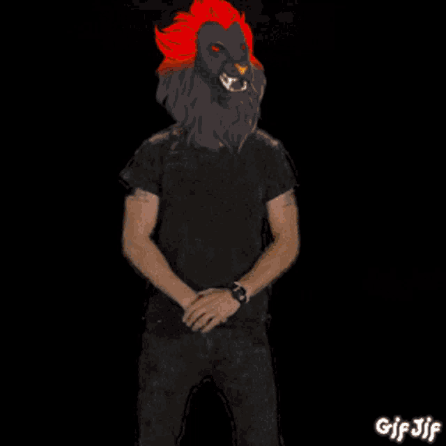a man in a lion mask stands in front of flames and says do it !!!
