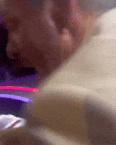 a close up of a man 's face with a purple background