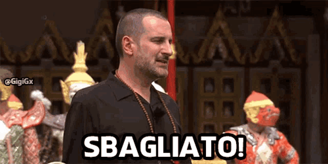 a man with a beard is standing in front of a group of people and says sbagliato