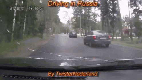 a car is driving down a road in russia and the time is 14:50
