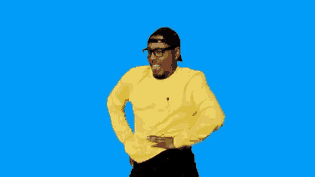 a man wearing a yellow sweater and a hat is dancing on a blue background .