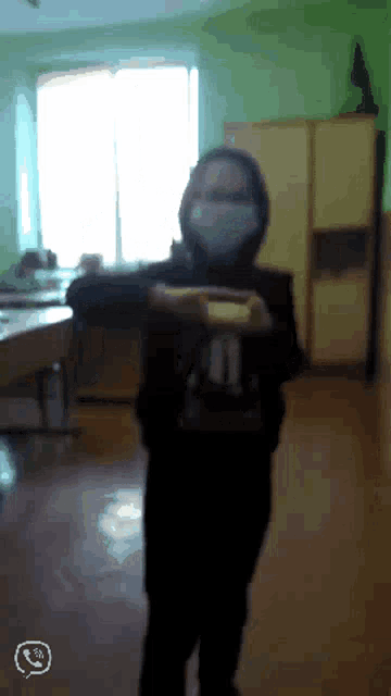 a person wearing a mask with the number 11 on the back