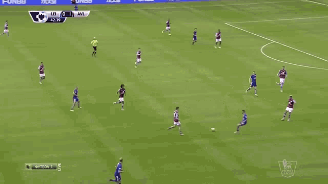 a soccer game is being played on a field with advertisements on the walls