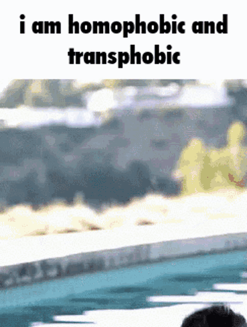 a man is swimming in a pool with the words i am homophobic and transphobic