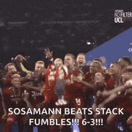 a group of soccer players are holding a trophy in the air .