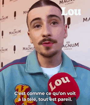 a man is talking into a lou microphone